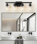 Top Shelf 4 Light Bathroom Vanity Light With Clear Glass Sleeves Matte Black Vintage Wall Sconce above modern sinks and mirror.