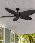Duval 52 Inch Indoor Outdoor Ceiling Fan With Hand Carved Basswood Blades, Bronze Finish, installed on a porch ceiling