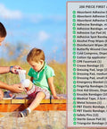 First aid kit refill, 200-piece loose-packed supplies, man bandaging a child's leg outdoors beside a supplies list.