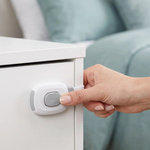 Hand using 10 Pack Child Safety Cabinet Locks Easy Install Plastic Latches For Cabinets Drawers Fridge Oven Toilet Kitchen Cupboards And Appliances Gray Durable Plastic Construction For Kid Proofing In Every Room on white cabinet with latch.