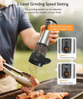 Close-up of Electric Salt And Pepper Grinder Set With 2 Speed Modes 5 Coarseness Settings over steak on grill