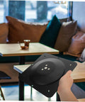 Modern Table Leg Brackets And Heavy Duty Mounting Plates For Furniture Legs Dead Easy Install Dining Table Hardware solid steel black mounting plate hand-held in cafe setting.