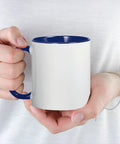 Hand holding a Premium Ceramic Coffee Mug 11 Oz Featuring Fastest Cart Graphic Art, white with blue handle, ideal for home or office.