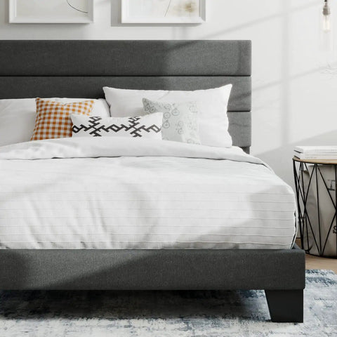 Full Platform Bed Frame With Upholstered Fabric Headboard In Grey Featuring Dense Foam Padding And Breathable Polyester For Super Comfy Nights, with pillows and white bedding.