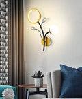 Top Shelf Modern Wall Sconce Packed With Crystal Trim And Slick Three Color Dimmable Lighting For Master Bedrooms Living Rooms And Hallways Wire Drawn Metal Body on a wall with two light shapes.
