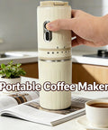 Portable Travel Coffee Maker With Built In Grinder 16 Oz Brew Cup One Touch Manual Drip Brewer in hand on kitchen counter.