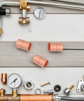 Premium Copper Coupling Fittings 0.59 Inch Straight Pipe Connectors with Grooved Stop Mechanism on work surface.