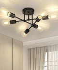 Modern ceiling light fixture with six exposed bulbs, black metal finish, and visible wiring in a living room setting.