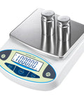 High Precision Digital Lab Scale 6000g X 0.01g with Large LCD Display showing 1kg weight, stainless steel pan with weights