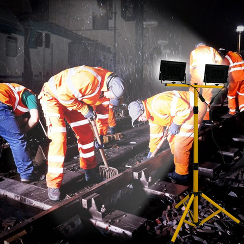Two-Head LED Work Light With Adjustable Foldable Tripod Stand, 21000 Lumen Portable Flood Light illuminating a job site at night