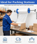 Kickass Heavy Duty Wall Mount Bubble Wrap Roll Dispenser in use for packing boxes at a workspace with bubble wrap and supplies.