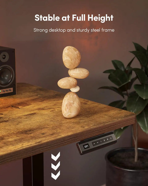 Large One Piece Standing Desk 48 By 24 With Electric Height Adjustment, Rustic Brown, displaying stability with stacked stones.