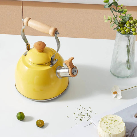 Yellow 1.6 Quart Tea Kettle With Cool Touch Wooden Handle Food Grade Stainless Steel Stovetop Teapot Whistling Kettle displayed on a table