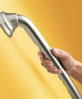 Heavy Duty 16 Inch Bathroom Grab Bar With Curled Grip In Brushed Nickel Finish held by hand on a yellow background