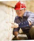 Cut Resistant Wrist Sleeves With Breathable Forearm Guards Offering Rock Solid Protection For Men And Women Grabbing Tools For Gardening Auto Repair Or Shop Work Without Breaking A Sweat During The Daily Grind worn by worker inspecting wall