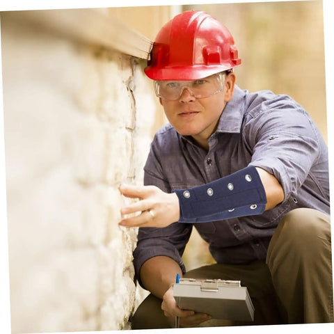 Cut Resistant Wrist Sleeves With Breathable Forearm Guards Offering Rock Solid Protection For Men And Women Grabbing Tools For Gardening Auto Repair Or Shop Work Without Breaking A Sweat During The Daily Grind worn by worker inspecting wall