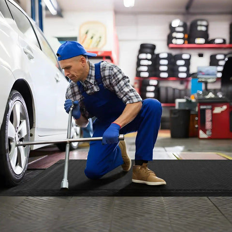 Mechanic installing tire on Heavy Duty Anti Fatigue Floor Mat 3 Feet By 6 Feet 15 To 16 Inch Thick Diamond Plate Memory Foam Ergonomic