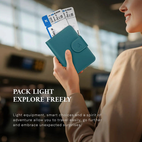 Person holding RFID Passport Holder Travel Wallet For Men And Women With Hidden AirTag Slot Genuine Leather Passport Cover, Lake Blue.