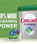 Packaging of Cascade Platinum ActionPacs Dishwasher Detergent Pods with 50% more cleaning power shown next to a detergent pod.