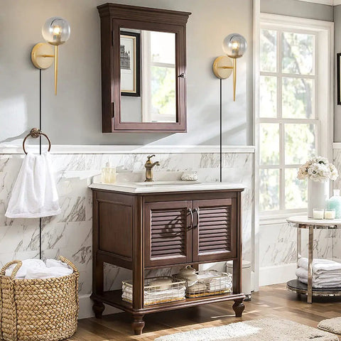 2 Light Plug In Globe Wall Sconce With Smoky Gray Glass Shade And Brass Finish in a cozy bathroom setting