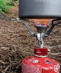 Ultralight Folding Camping Stove That Fits In Your Pocket, Boils 1 Liter In About 3.5 Minutes in use with red gas canister.
