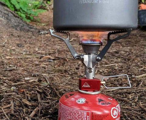 Ultralight Folding Camping Stove That Fits In Your Pocket, Boils 1 Liter In About 3.5 Minutes in use with red gas canister.