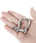 Hand holding Rugged 3/8 Inch 304 Stainless Steel Screw Pin Anchor Shackle from set of 10, showing size and build quality for marine use.