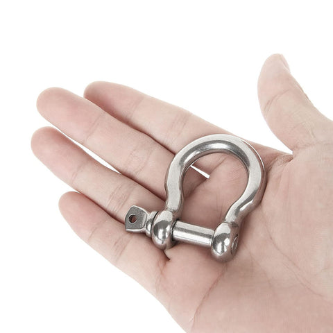 Hand holding Rugged 3/8 Inch 304 Stainless Steel Screw Pin Anchor Shackle from set of 10, showing size and build quality for marine use.