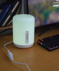 Short White Indoor Extension Cord Two Foot, Polarized 2 Prong NEMA 5-15P to 5-15R connected to a desk lamp