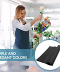 Florist holding bouquet with Black Flower Wrapping Paper For Bouquets, Lightweight Floral Paper With Cuttable Design, 40 Sheets.