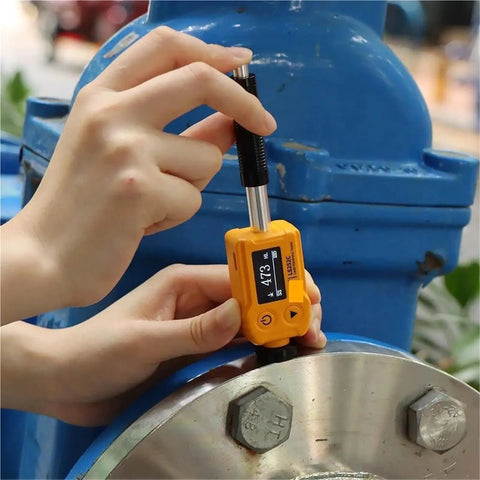 Hassle Free Universal Hardness Tester For Steel Aluminum And Metal Alloys measuring hardness on metal surface with digital display.