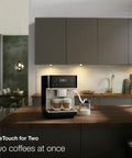 Top Shelf Fully Automatic Coffee And Espresso Maker Featuring Quiet Steel Grinder And Rich Milk Frother For Smooth Real Deal Brews And Quick Daily Home Satisfaction on kitchen counter making two coffees.