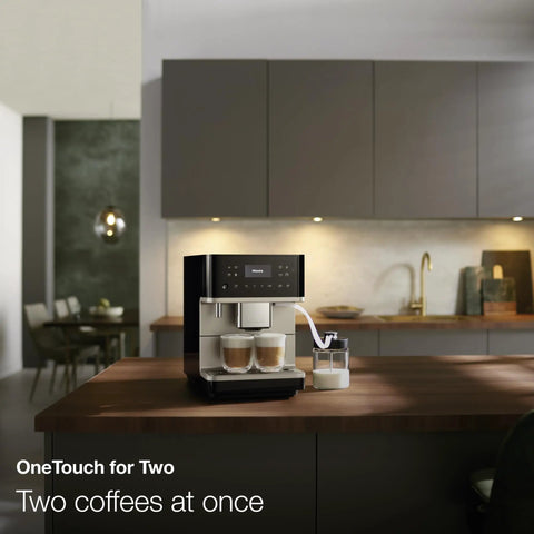 Top Shelf Fully Automatic Coffee And Espresso Maker Featuring Quiet Steel Grinder And Rich Milk Frother For Smooth Real Deal Brews And Quick Daily Home Satisfaction on kitchen counter making two coffees.