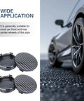 Premium Snap On Wheel Hub Center Caps For Universal Fit, Carbon Fiber Black Look, two caps on textured surface with vehicle wheel.