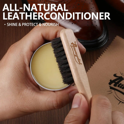 Premium Eleven Piece Leather Care Kit With Horsehair Brushes Rich Saddle Soap Conditioning Mink Oil Waterproofing Wax Soft Polishing Cloths And Microfiber Pads showing hand holding horsehair brush over leather conditioner.