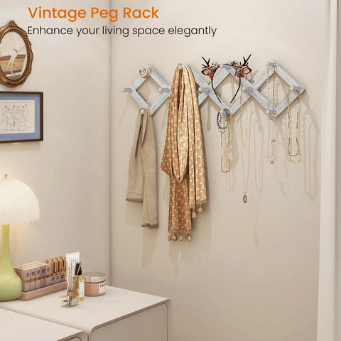 Accordion Style Wall Mounted Coat Rack With 13 Peg Hooks For Coats Hats Bags Mugs And Necklaces In Rustic White Finish in living room