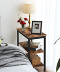 Rustic Brown And Black 3 Tier End Table With Open Storage Shelves Sleek Industrial Side Stand Fits Snugly In Tiny Spaces beside a bed.