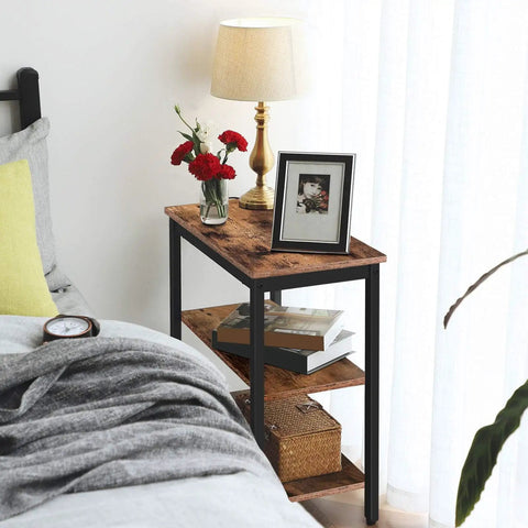 Rustic Brown And Black 3 Tier End Table With Open Storage Shelves Sleek Industrial Side Stand Fits Snugly In Tiny Spaces beside a bed.