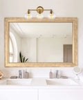22 Inch Modern Three Light Vanity Bathroom Light With Clear Glass Globe Shades And Warm Brass Finish For Rustic Farmhouse Vibe And A Sharp Stylish Powder Room Glow mounted over a double sink bathroom mirror