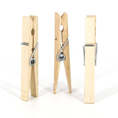 Tough As Nails Wooden Clothespins With Heavy Duty Spring Clip For Line Drying Laundry And Chip Bag Sealing Rust Resistant Coiled Design Non Slip Grip Bulk Pack Of 50 showing three wooden clothespins.