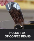 Pouring coffee beans into Home Barista Ready Burr Coffee Grinder With 12 Grind Settings And 8 Oz Capacity in stainless steel