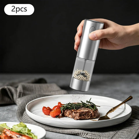 Touch Activated Automatic Electric Spice Grinder With Soft Glow LED Light Salt And Pepper Mill For Kitchen Countertop in use on steak dish