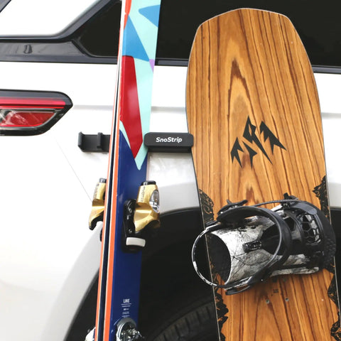 Badass Magnetic Ski And Snowboard Vehicle Rack Keeping Your Ride Spotless With Soft Waterproof Padding For Reliable All Season Winter Storage And Trail Ready Adventures mounted on car with skis and snowboard.