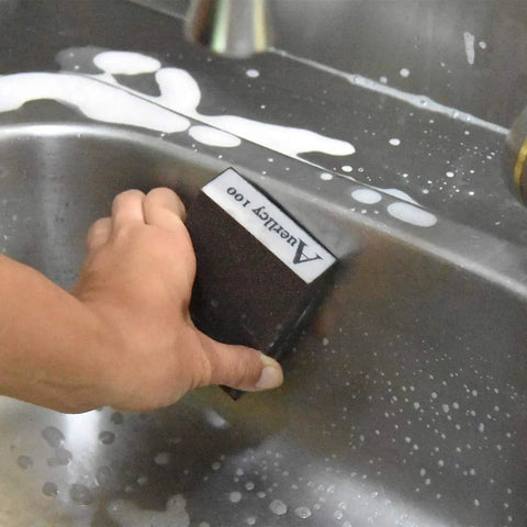 Person using Four Grit Sanding Sponge Set 60 80 120 220 Grits, 4 x 2.8 x 1 Inch Assorted Block on metal surface in sink
