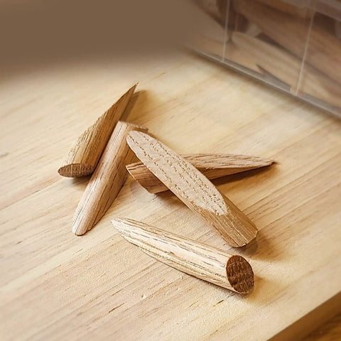 Hella Sturdy Oak Wood Plug Set For Screw Holes Odorless Reusable Pocket Hole Inserts With Sandable Finish No Fuss Diy Wood Filler Plugs Bulk Pack Of Fifty on a wooden surface.