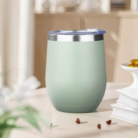 12oz Double Wall Vacuum Insulated Stemless Wine Tumbler With Straw And Lid Stainless Steel Cup on table in soft green color.