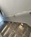 Sleek Transparent Acrylic Handrail With Heavy Duty Silver Wall Mount Brackets For Indoors Outdoors Stair And Deck Safety Featuring Bubble Design Supporting Four Hundred Forty Pounds Built Like A Tank For Daily Grind mounted on a staircase wall.