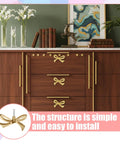Six Pcs Gold Bow Knobs Set With Screws, Vintage Brass Drawer Handles For Cabinets And Dressers, Cupboards, Antique Gold Finish, Elegant Hardware For Kitchen, Bedroom, Or Bathroom Decor shown installed on wooden dresser