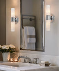 Dual 14 Inch Modern Wall Sconce With Frosted Glass Cylinder Shades In Chrome Finish in bathroom setting