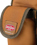 Close-up of Bucketeer Bucket Tool Organizer label and pocket in brown, fits most 5 gallon buckets with loops for long tools.